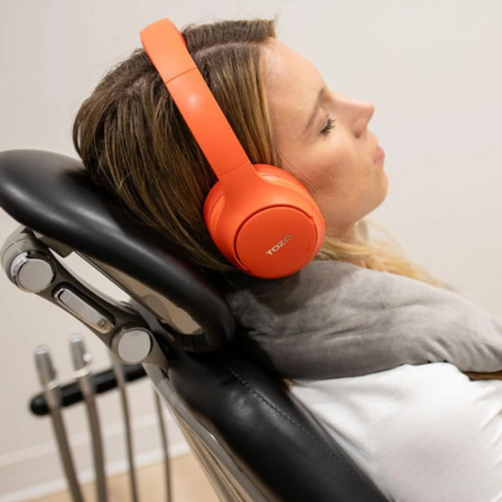 Patient wearing headphones during a comfortable dental treatment