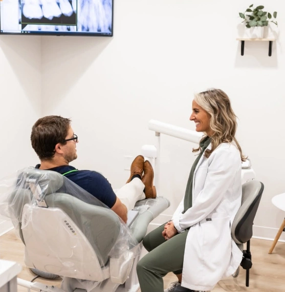 Dentist explaining dental bridge treatment to a patient