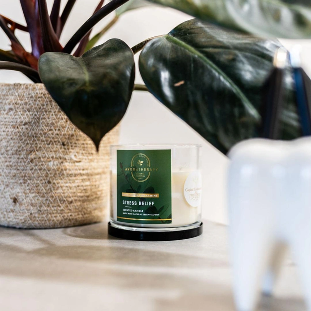 Scented candle placed beside a plant
