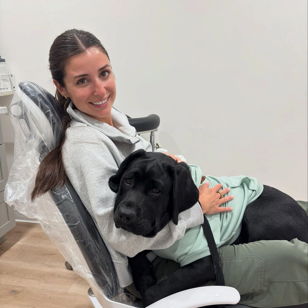 Dentist holding a dog to create a welcoming and friendly office environment
