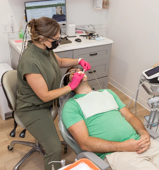 Dental professional providing cold sore treatment