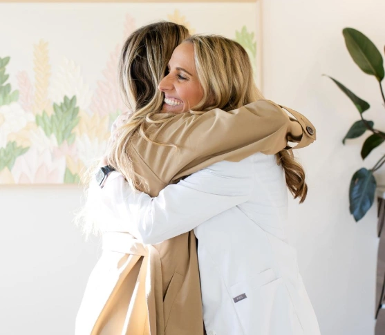 Patient receiving a warm welcome with a friendly hug at the dental office