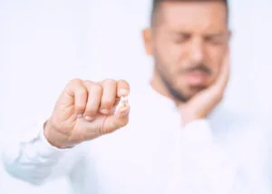 Man holding his cheek due to a painful toothache