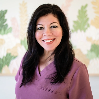 Portrait of Marie, a smiling member of the dental practice team