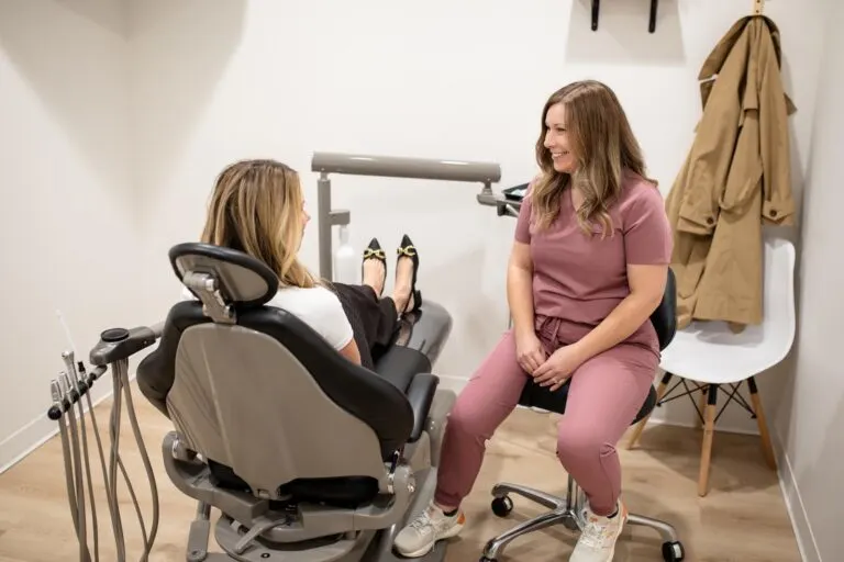 Dentist talking with a patient in the treatment room