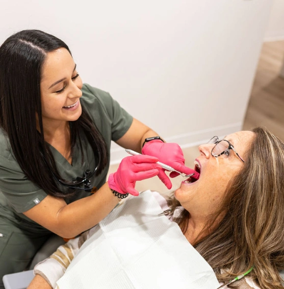 Dental professional performing specialized dental treatment