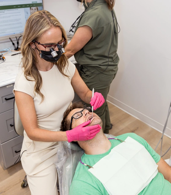 Dental professional evaluating a patient for TMJ disorder treatment